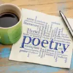 Cup of coffee and a napkin with "Poetry" printed, beside an ink pen